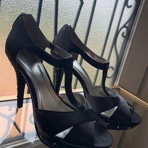 Rhinestone black strap heels .